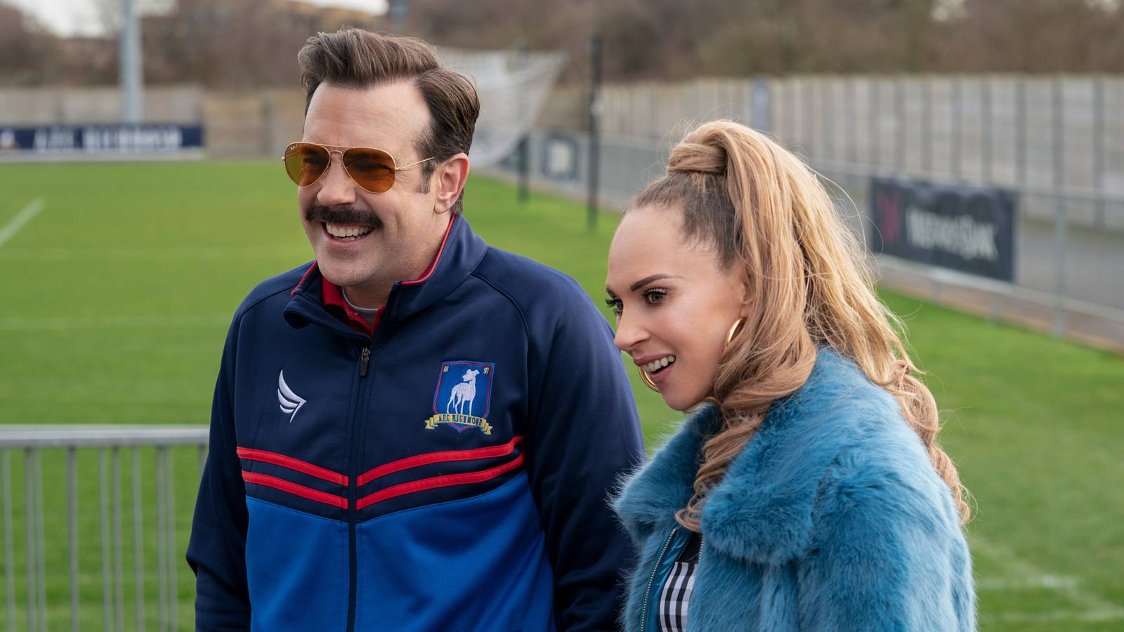 Jason Sudeikis as Ted Lasso and Juno Temple as Keeley Jones on the training ground in Ted Lasso