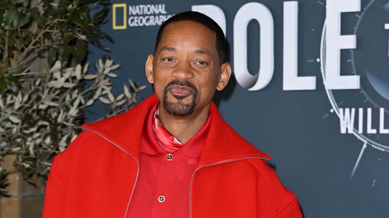 Will Smith wearing a red shirt and jacket at the Pole to Pole London premiere