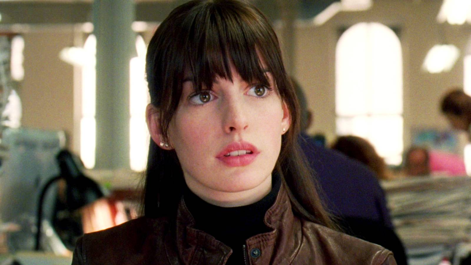 Anne Hathaway in a newspaper office as Andy Sachs in The Devil Wears Prada