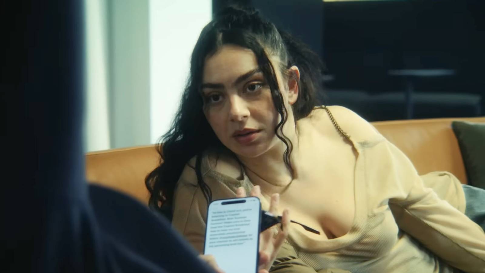Charli XCX speaking to someone in The Moment
