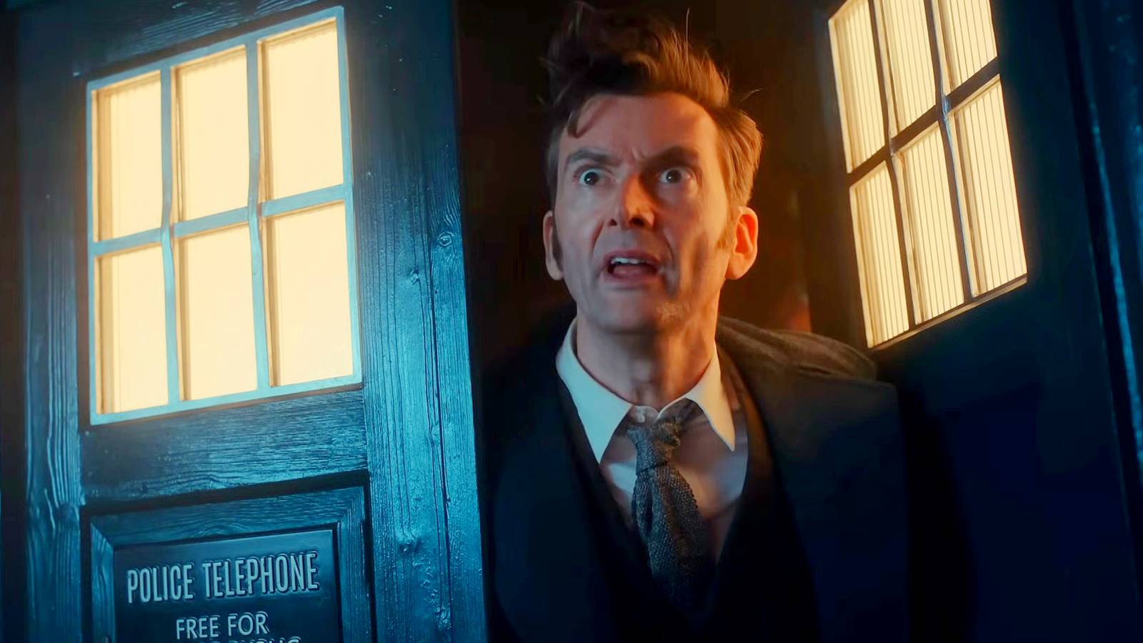 David Tennant as the Fourteenth Doctor leaning out of his TARDIS in Doctor Who