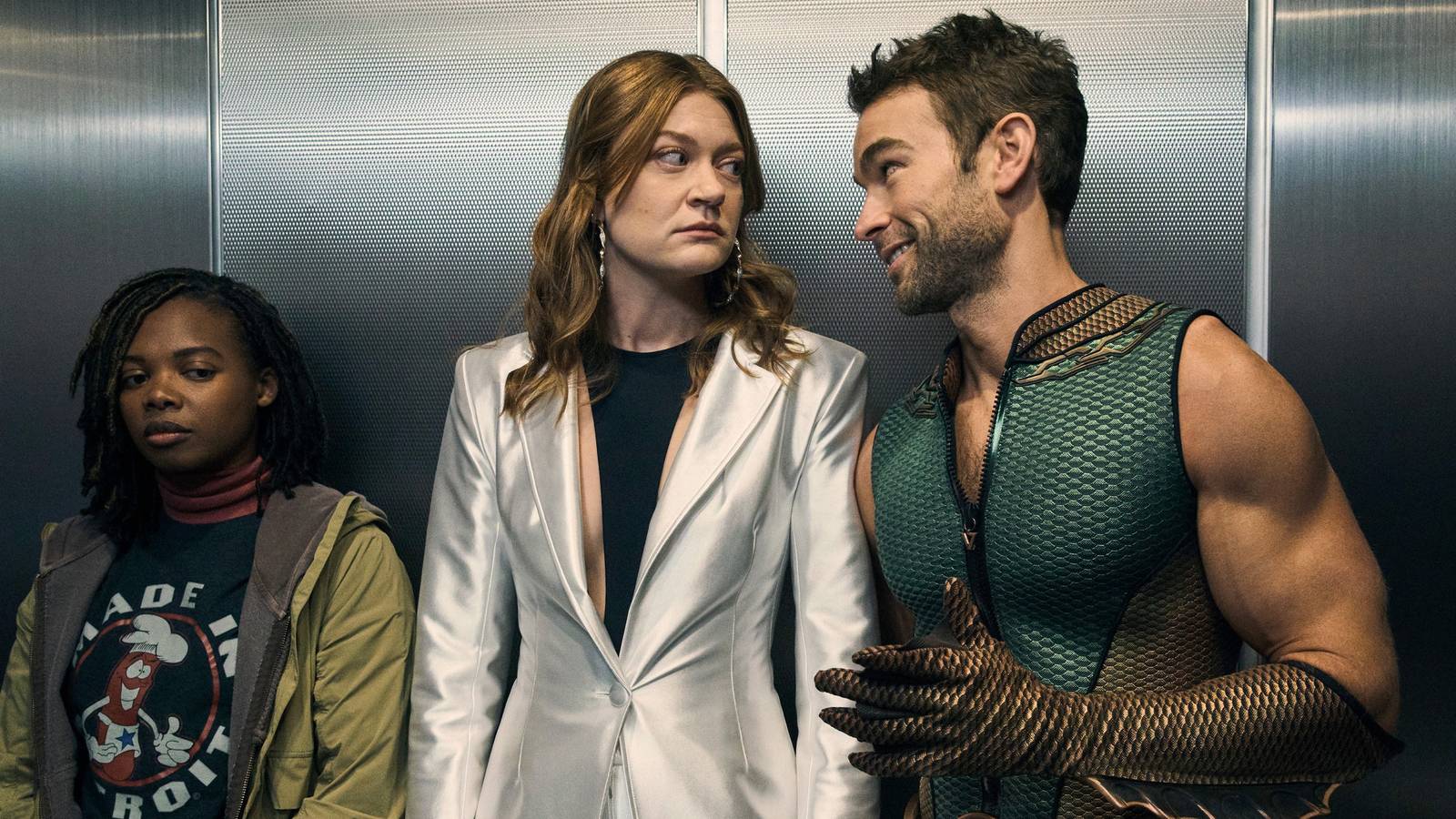 The Deep and Ashley looking at each other inside an elevator while Sister Sage stands beside them...