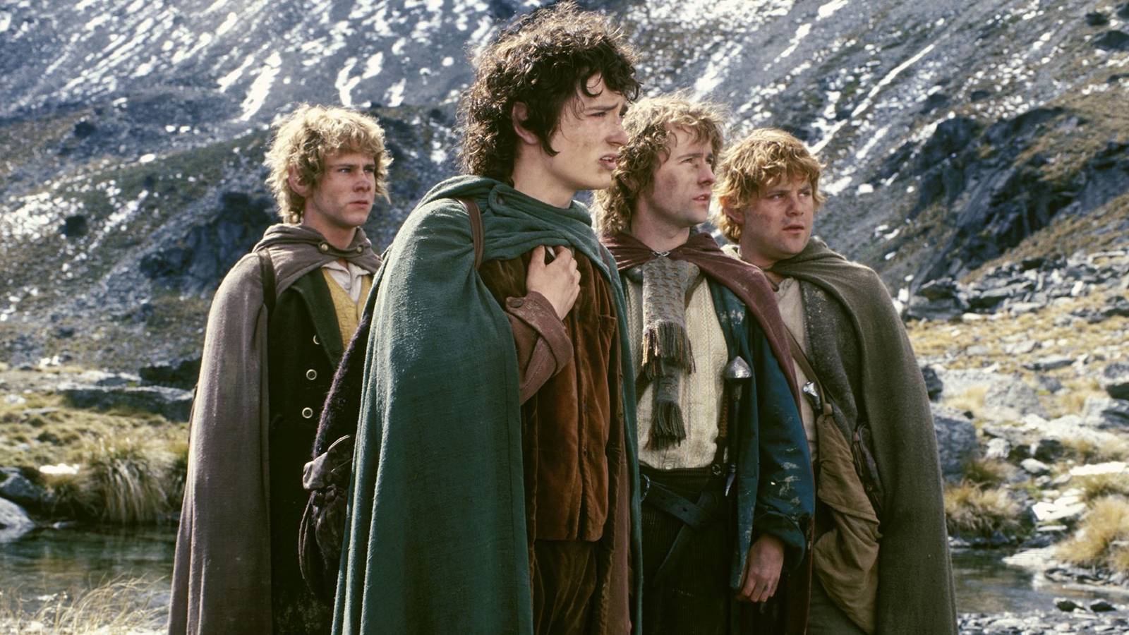 The four hobbits by a mountain in The Lord of the Rings