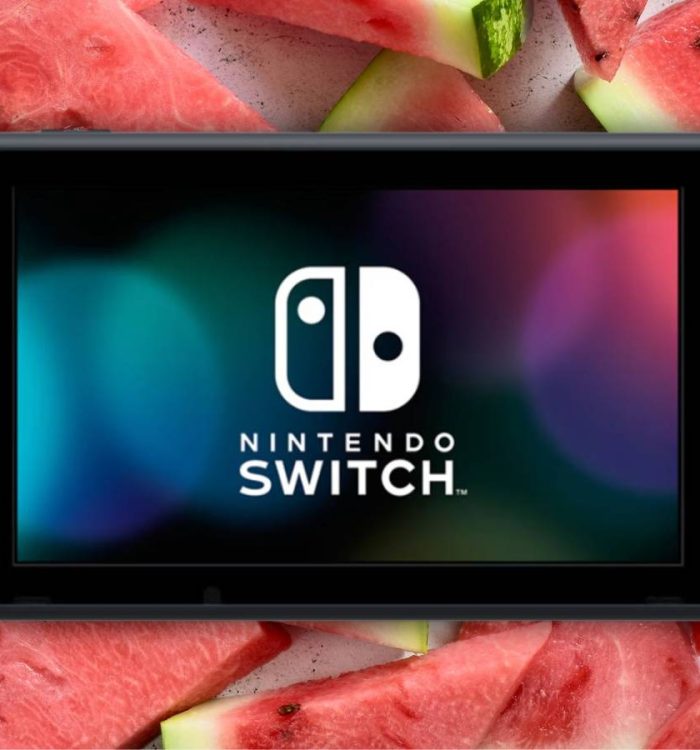 A Nintendo Switch in front of slices of watermelon